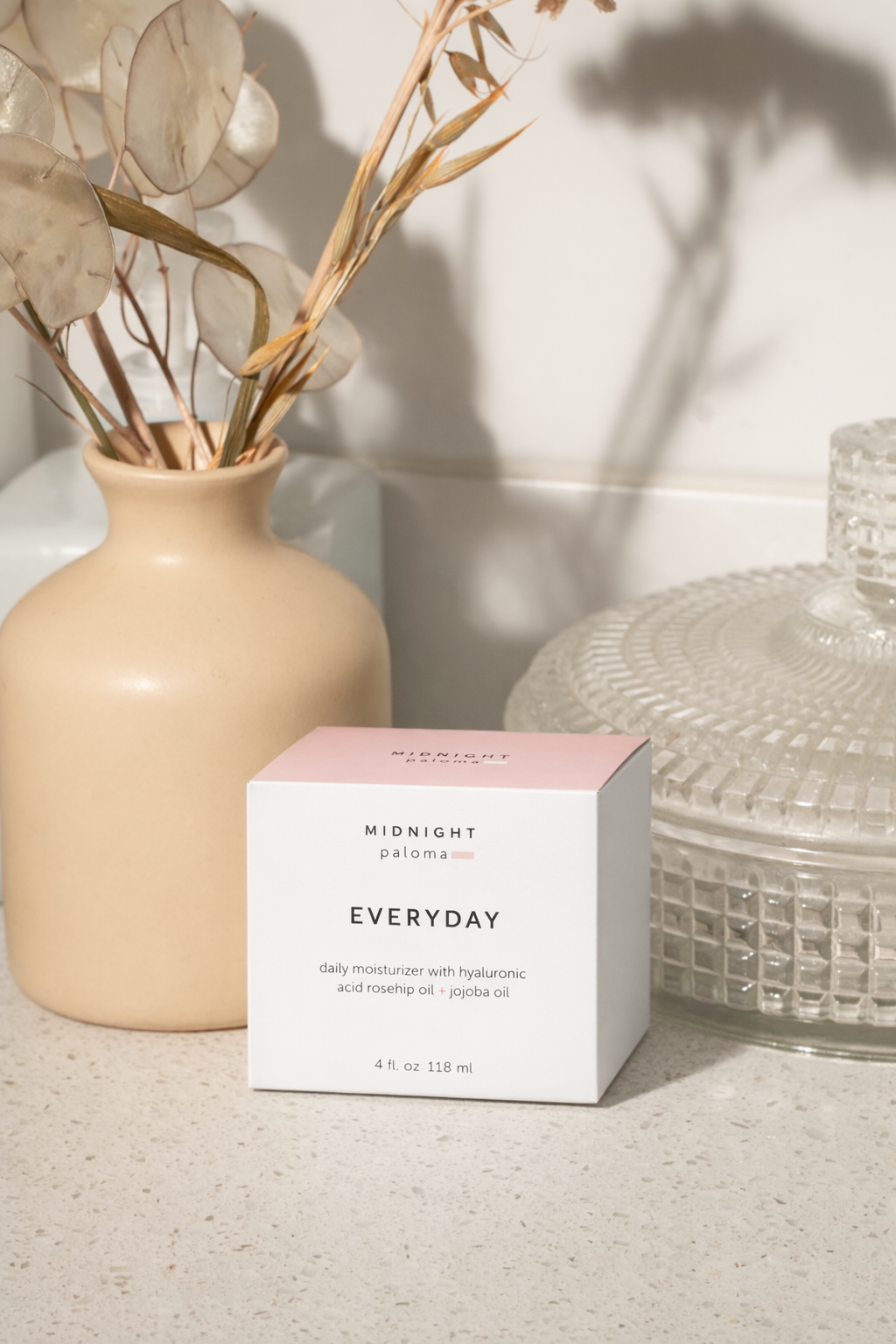 Box of 'Everyday' product by 'Midnight Sun' with a vase and decorative items in the background.