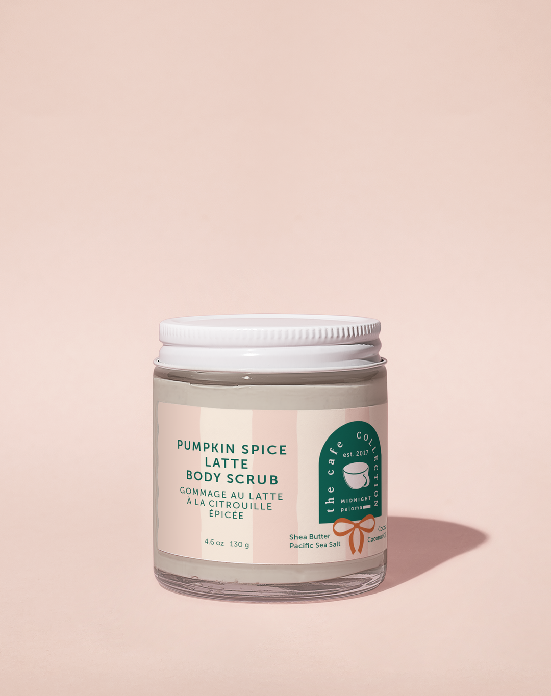 Pumpkin Spice Latte body scrub jar with a pink label on a beige background