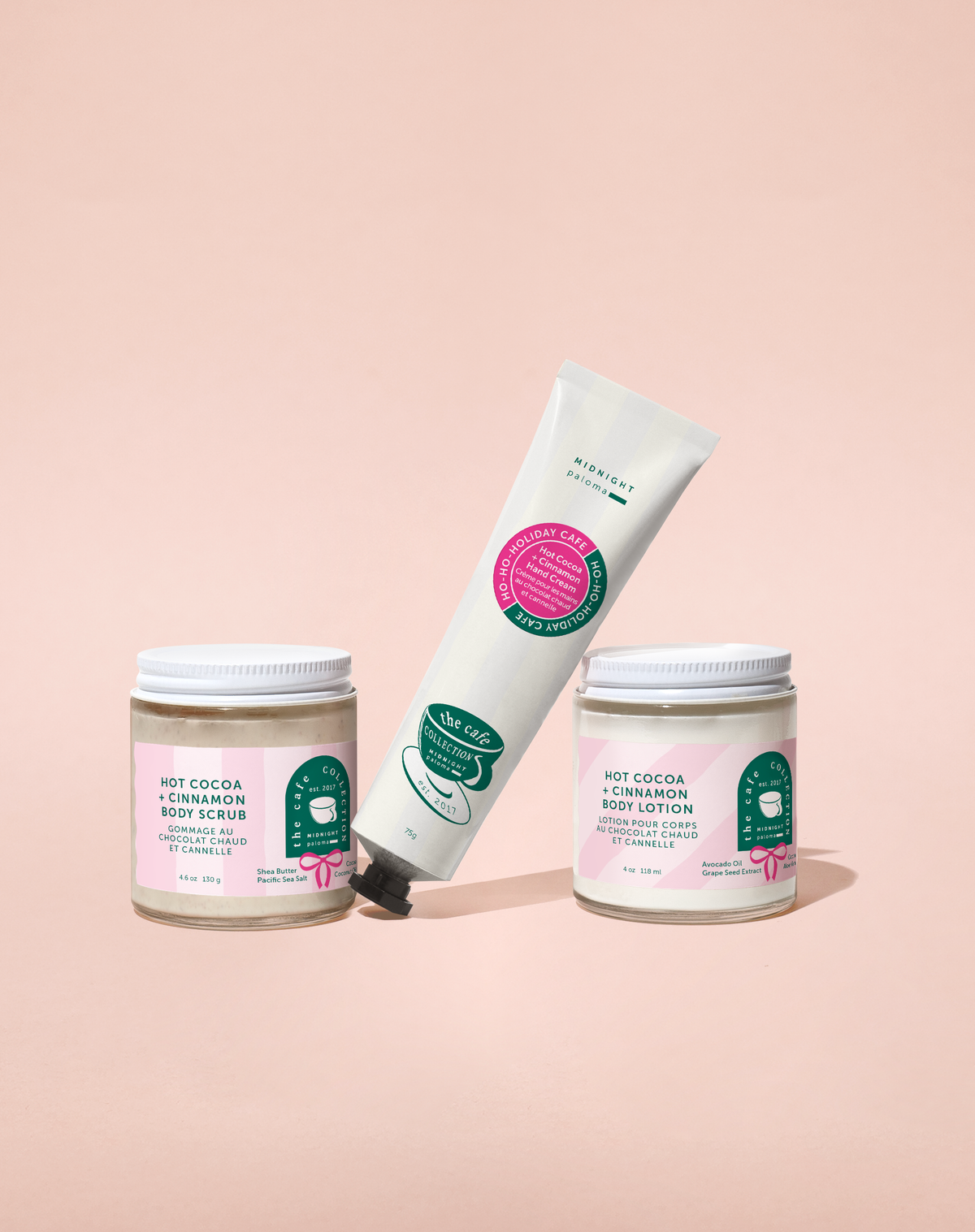 Three skincare products on a pink background