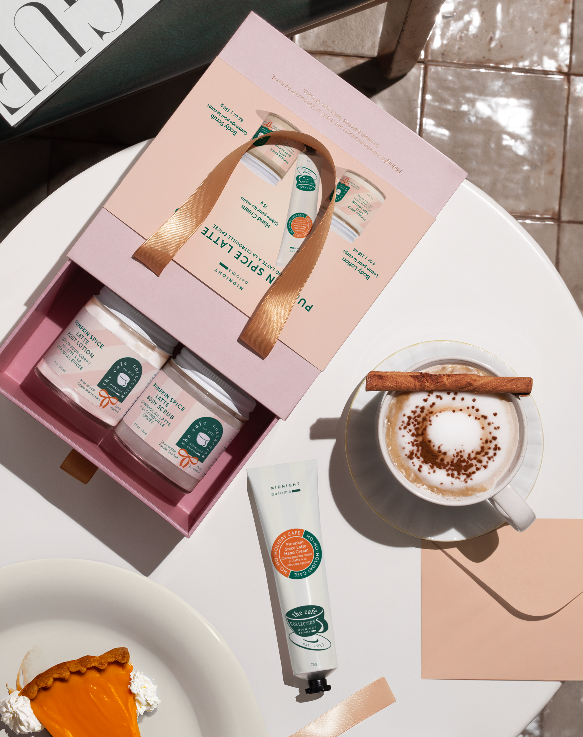 Cosmetic set with jars, a tube, and a cup of coffee on a table.